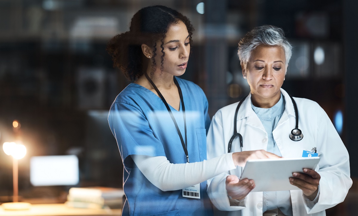 Doctors, nurse and digital tablet for night teamwork, medical research and surgery planning in wellness hospital. Talking, healthcare and worker women in collaboration on technology for late thinking. | Virtual Assistant For Doctors