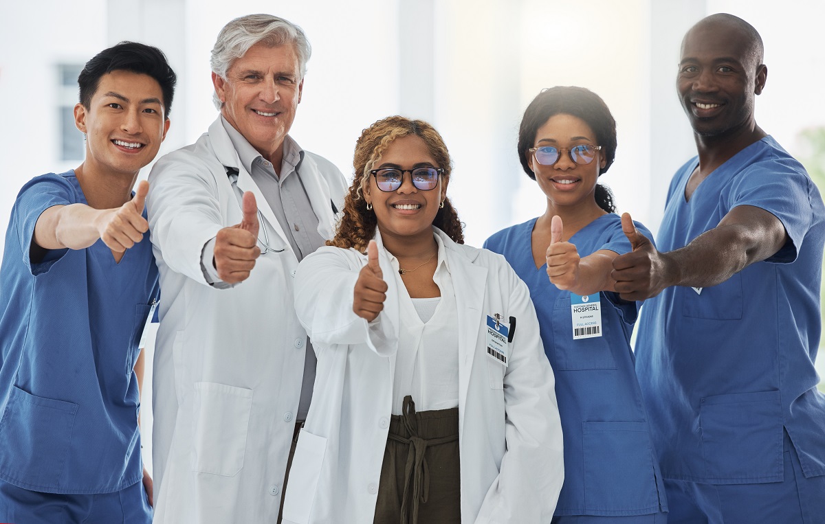 A Group of Medical Practitioners Showing Thumbs Up Together in a Hospital | VAForDoctors