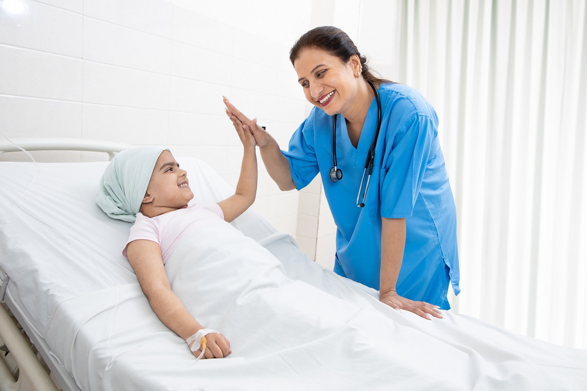 Doctor Giving a High Five to a Child in a Hospital Bed | VAForDoctors