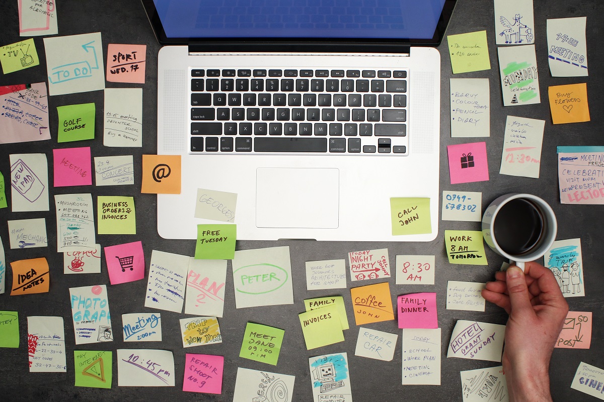 Top View on Messy Office Desk With Laptop and Coffee | VAForDoctors